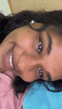 a close up of a woman 's face with her mouth open