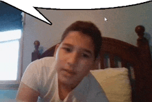 a boy in a white shirt is laying on a bed with a speech bubble above him