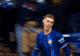 a soccer player celebrates a goal in front of a screen that says goal