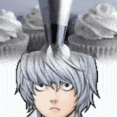 a close up of a person 's head with a cupcake in the background .