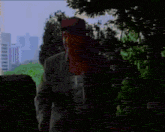 a man in a suit and red hat is clapping his hands in front of a colorful background