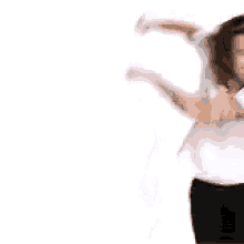 a man is dancing in front of a white background .