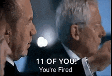 a man in a suit and tie is talking to another man in a suit .