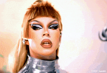 a close up of a drag queen 's face with the words t4yce tumblr in the bottom right corner