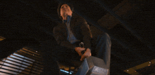 a man in a suit is holding a hammer