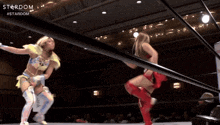 two women are wrestling in a ring with the words stardom on the bottom