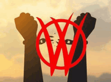a silhouette of two fists with chains around them and a red circle with the letter w .