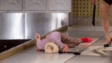 a woman is laying on the floor with her head in her hands