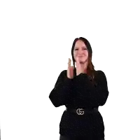 a woman wearing a black sweater and a gucci belt is clapping