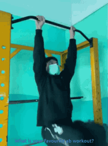 a man wearing a mask hangs from a bar with the words what is your favourite ab workout