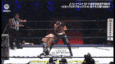 two men are wrestling in a ring with a referee in the background