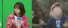 a woman is holding a card in front of a green screen and a boy is holding a card in front of his face .