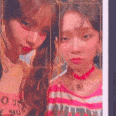 two young women are posing for a picture together .