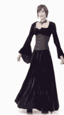 a woman in a long black dress is dancing