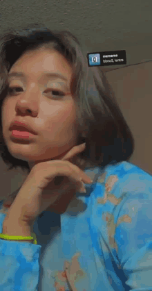 a woman in a blue shirt has a sticker on her wall that says siempre