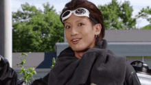 a young man wearing a scarf and goggles with the letter s on them