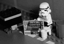 a lego storm trooper holding a sign that says " ceo 's call center odyssey "