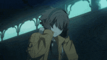 a man in a yellow jacket is standing in a dark room