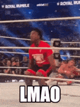 a man is kneeling in a wrestling ring with the words `` lmao '' written on the ground .