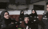 a group of women are standing in a room with a man wearing a badge that says ' police '