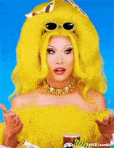 a woman in a yellow wig and sunglasses is holding a bag of pringles