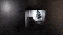 a dark room with a shadow of a person hanging from the ceiling
