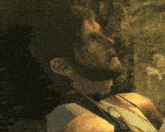 a man with a beard and headphones around his neck is looking up