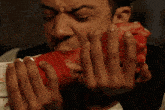 a man with blood coming out of his mouth and fingers