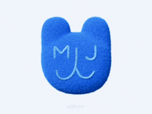 a blue pillow with the letter m and j written on it