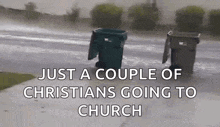 a couple of trash cans are sitting on the side of the road .