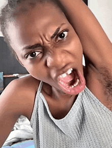 a woman is making a funny face with her tongue out