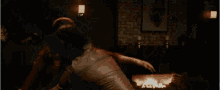 a man is cutting a piece of metal with a grinder and sparks are flying around him