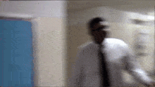 a blurry picture of a man in a white shirt and tie in a bathroom