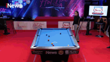 a pool table with the word news on the side of it