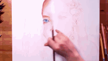 a person is painting a woman 's face with colored pencils