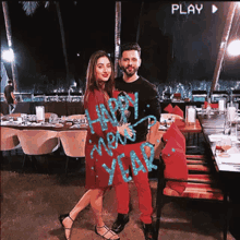 a man and a woman are posing for a picture with the words happy new year written on their shirts