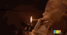 a person lighting a cigarette with a lighter that says zee tv