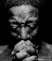 a black and white photo of a man with his hands folded and the caption fra tiktok-kommentar