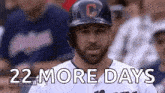a baseball player wearing a helmet and a jersey with the words `` 22 more days '' written above him .