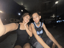 a man wearing a magic jersey sits next to a girl