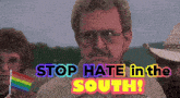 a man holding a rainbow flag with the words stop hate in the south behind him