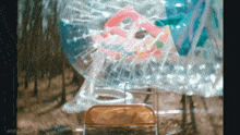 a chair is sitting in front of a bubble ball with the words aespagifs written on the bottom