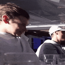 a man wearing a white hat is looking down at something