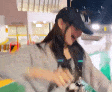 a blurry picture of a woman wearing a hat with ny on it