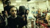 a group of young men are standing in a grocery store looking at a shelf .