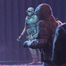 two soldiers are standing next to each other on a stage in a video game .