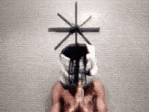 a shirtless man with a cross on his head is praying