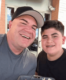 a man and a boy are smiling for the camera