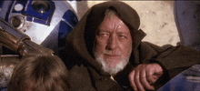 a man with a beard wearing a hooded cape