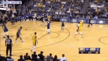 a basketball game is being played on a court with a sportsnet live advertisement